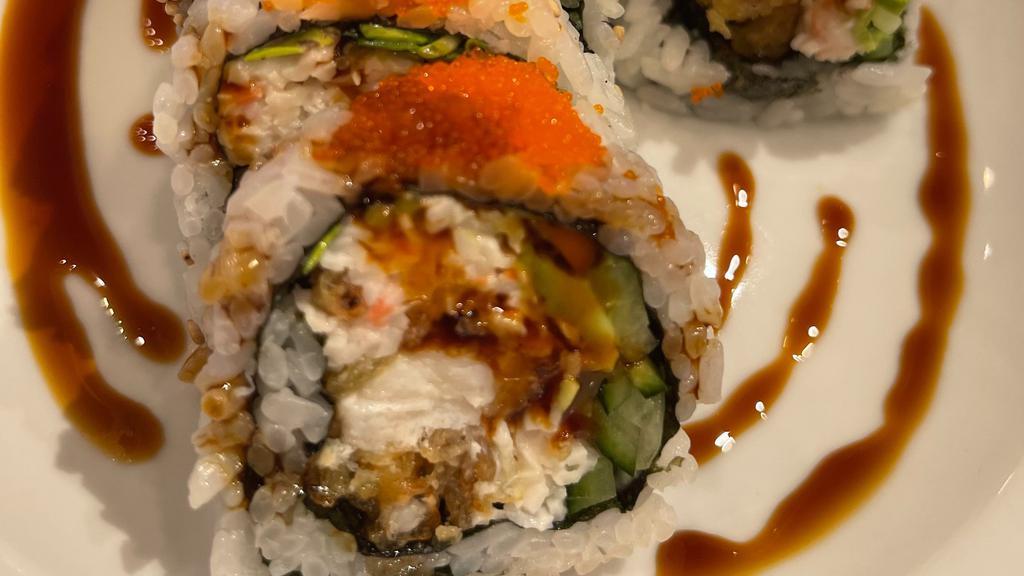 Spider Roll · Soft shell crab, crab meat, avocado, cucumber, mountain carrot, and radish sprout inside topped with smelt egg, served with sweet eel sauce.