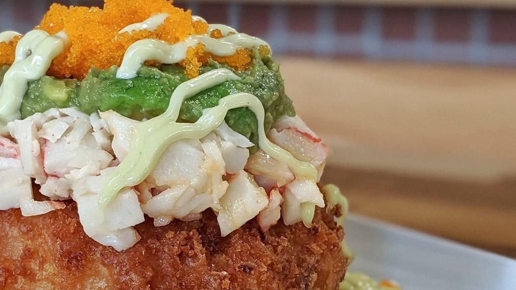 Sushi Donut · sticky rice stuffed with cream cheese, deep fried and topped with avocado, crab salad, masago, and wasabi mayo