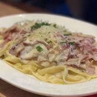 Fettuccine Carbonara · Ham and bacon in alfredo sauce with shaved parmesan cheese.