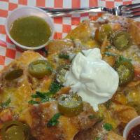 Homemade Nachos Steak Or Chicken · Tortilla chips, beans, Monterey and Jack cheese, onions, tomato, sour cream, jalapeños, red ...