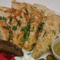 Steak Quesadilla · With caramelized onions, sour cream, and jalapenos