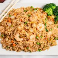 Shrimp Fried Rice · Rice stir fried with bits of shrimp onions carrots and peas in soy sauce.