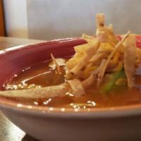 Chicken Tortilla Soup · Served with avocado, tortilla strips, chicken, and cheese.