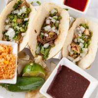 Street Tacos (2 Pieces) · Choice of chicken, steak, or carnitas, served with onions, cilantro, and salsa mesa.