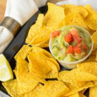 Chips And Guacamole · Four-ounce bowl of guacamole with chips.