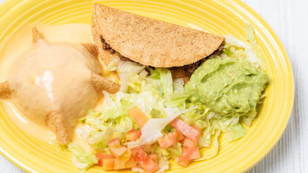 Light Combo No. 1 · A crispy taco, side of guacamole,
a puff chile con queso, and a choice of beef, chicken or cheese enchilada.
