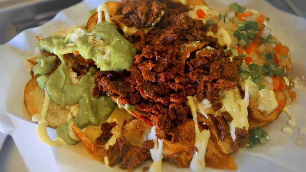 Carne Asada Fries · Showing Cali love with these bad boys! Crispy potato chips, Pico de Gallo, crema, guacamole, queso fresco and some cerveza queso. Pile on one of our signature meats, yes even tofu. A west coast classic.