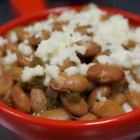 Drunken Beans · Slow cooked with the Mexican Trinity (tomatoes, jalapeños, and onions), sprinkled with queso...