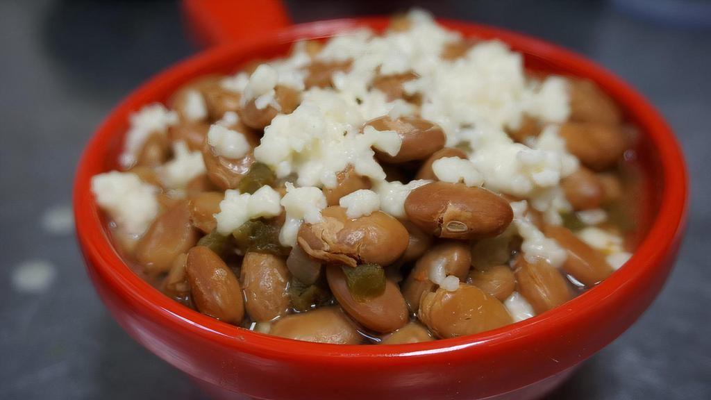 Drunken Beans · Slow cooked with the Mexican Trinity (tomatoes, jalapeños, and onions), sprinkled with queso fresco.  Make them ESPECIAL by adding meat and crema for $1 more.