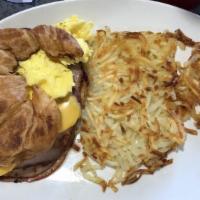 Breakfast Croissant · Choice of ham, bacon or sausage with two eggs and melted cheese. Served with hash browns.