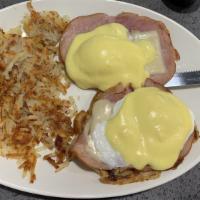 French Benedict · Two poached eggs with ham and swiss cheese on a croissant, all covered in hollandaise sauce....