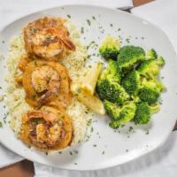 Crab & Shrimp Monaco · 3 grilled crab cakes on a bed of basmati rice topped with a Cajun cream sauce and jumbo shri...