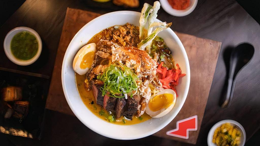 Surf & Turf Ramen · Soft shell crab tempura & tender NY strip steak in a combination of our house-made Tori and Tonkotsu broths served with yellow noodles, tempura scallion, soy-cured egg, crispy garlic, red ginger, fried onion, ginger butter