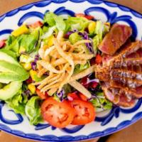 Seared Ahi Tuna Salad · Seared ahi tuna in a fig vinaigrette served aside mixed greens, fresh mangos and strawberrie...