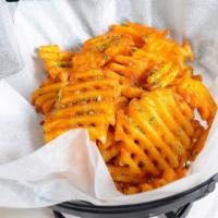 Waffle Fries · Waffle fries tossed with house seasoning and parmesan cheese, topped with parsley flakes. Se...
