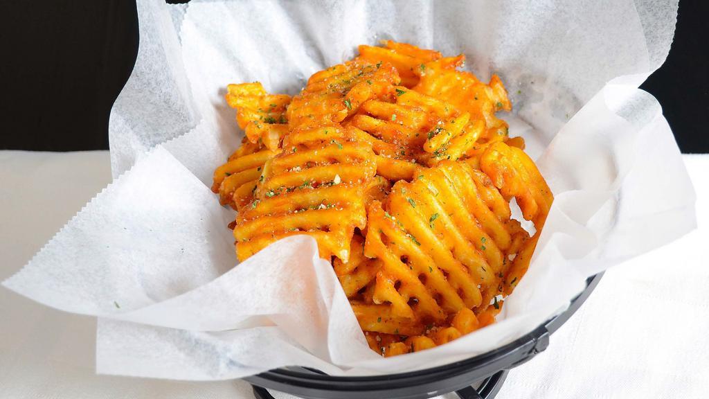 Waffle Fries · Waffle fries tossed with house seasoning and parmesan cheese, topped with parsley flakes. Served with spicy ketchup and spicy mayo.