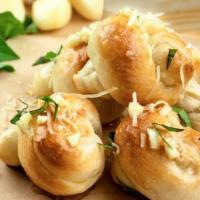 Garlic Knots · Hand-rolled and knotted fresh dough mixed with fresh diced garlic, butter, extra virgin oliv...