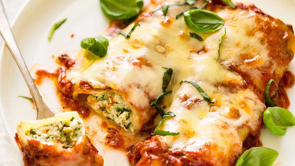 Cannelloni · Rolled pasta with ricotta cheese, beef, spinach topped in marinara, and mozzarella cheese on top.