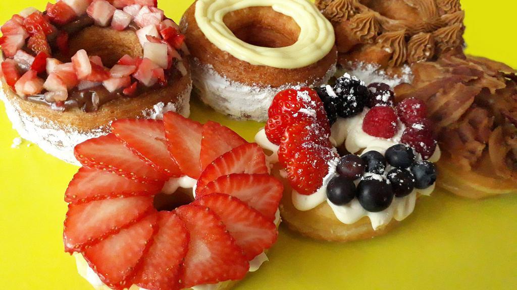 Half Dz Mix All Specialties · Mix of a cream cheese & berry donut, a maple & bacon donut, crème brulee donut, a 1-topping croissant donut and a 2-topping croissant donuts.