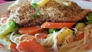 Parmesan Encrusted Tilapia · Served with sautéed vegetables & Cappellini in a garlic butter sauce.