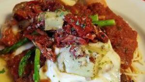 Tricolor · Chicken cutlet with fresh mozzarella, asparagus, sun-dried tomatoes and artichoke hearts.