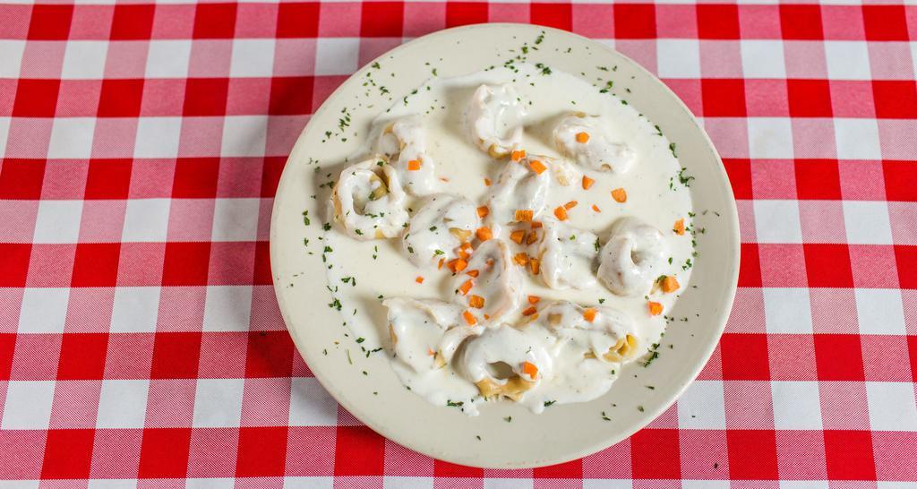 Tortellini · Spinach and sausage filled pasta with Alfredo sauce.