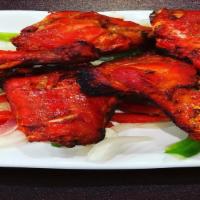 Tandoori Chicken · Chicken leg quarters marinated in fresh spices, herbs and yogurt, barbecued in tandoor oven
