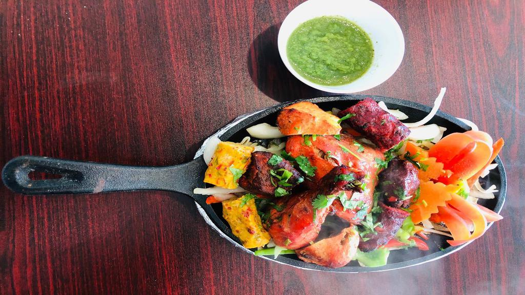 Mixed Grill · Tandoori Chicken, Chicken Seekh Kabab, Lamb Boti Kabab, Lamb Seek Kabab & Chicken Tikka seasoned in Indian herbs & spices & broiled in tandoor oven