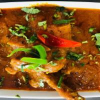 Goat Curry · Cooked with fresh Indian spices, garlic, onion, ginger, and tomato sauce