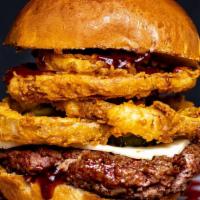 The 4-1-1 Burger · Beef patty pepper jack cheese topped with 4 thin onion rings bbq sauce on top and bottom bun...