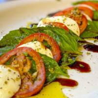 Insalata Caprese · Sliced roma tomatoes, fresh basil, fresh mozzarella, drizzled with extra virgin olive oil an...