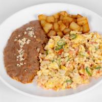 Huevos A La Mexicana · served with beans and potato breakfast. Eggs with tomato, onions, jalapeño, and flour or cor...