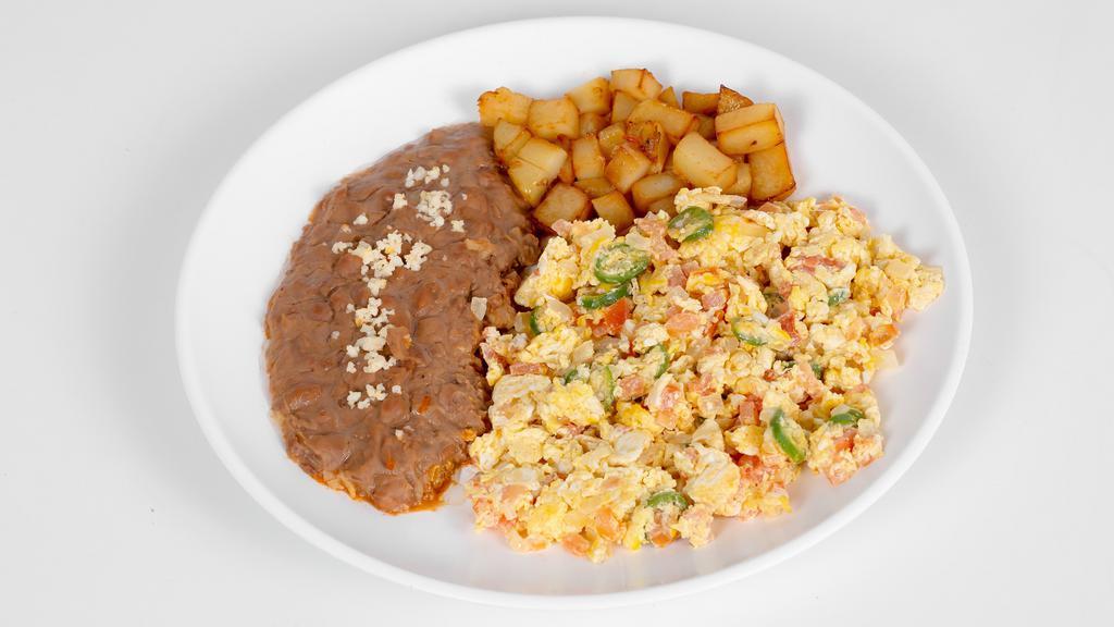 Huevos A La Mexicana · Scrambled eggs with jalapeño, onion, and tomato. Choice of corn or flour tortilla. Served with a side of beans and a side  of potatoes.