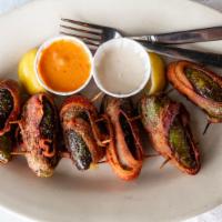 Hula Poppers · Six jalapenos stuffed with shrimp and cheese then wrapped in bacon.