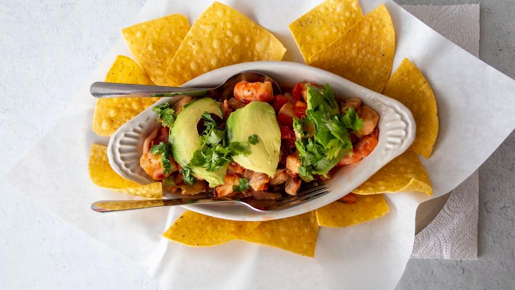 Ceviche · Tilapia marinated in lime for 6 hours then mixed with worchestershire, tabasco, onion, and jalapeno and topped with cilantro and avocado. Served with tortilla chips.