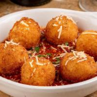 Arancini · Homemade Sicilian stuffed Parmesan risotto balls, served with meat sauce