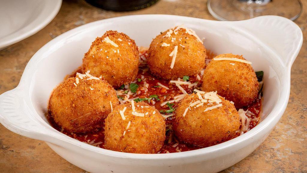 Arancini · Homemade Sicilian stuffed Parmesan risotto balls, served with meat sauce
