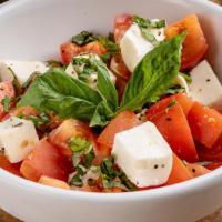 Mozzarella A La Caprese · Fresh mozzarella, vine-ripened tomatoes and fresh basil drizzled with extra virgin olive oil
