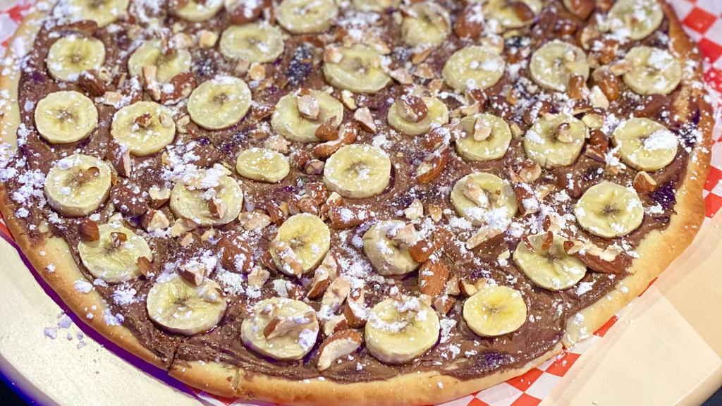 Nutella Pizza · For Hazelnut chocolate spread lovers! Fell the sugar rush with Nutella spread with bananas over it.