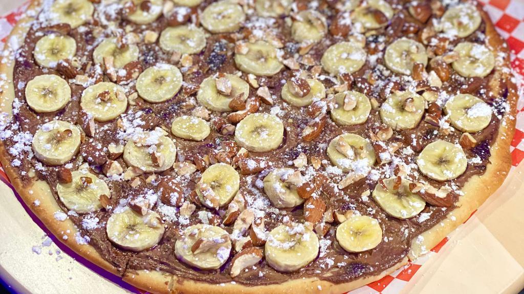 Nutella Pizza · For hazelnut chocolate spread lovers fell the sugar rush with nutella spread with bananas over it.