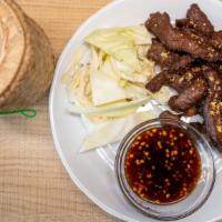 Nua Sawan (Thai Beef Jerky) · Marinated thin slices of beef oven-dried and fried to perfection. Served with sticky rice.