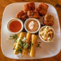 Yuca Frita Con Chicharron · Yuca fries with fried pork. Served with a chipotle mayo dip, salsa and Salvadoran pickled sl...