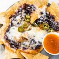 Nachos · Black beans, queso blanco, salsa fresca & jalapeños.