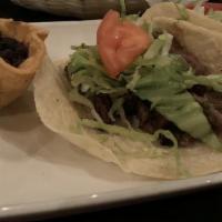 Tacos · Served with shredded lettuce, queso blanco, tomato & roasted onion.