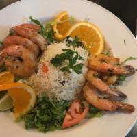 Camarones A La Plancha · Colossal gulf shrimp sautéed in olive oil with garlic & cilantro. Served on Mexican rice, ga...