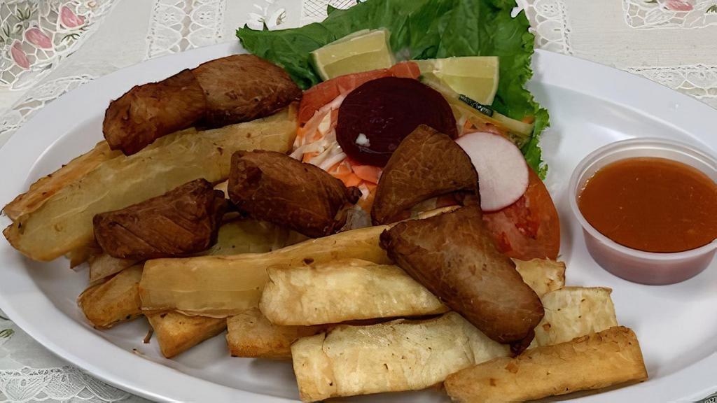 Yuca Con Chicharron(Yuca With Pork) via Tipicos Ay Caramba Restaurant