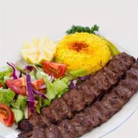 Ground Beef Kabob · One ground beef skewer kabob and salad and rice and veggie grill.