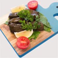 Veg Grape Leaves (Dolma) · The grape leaves stuffed with ground tomato, onion, parsley, lemon, olive oil, and spices.