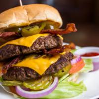 Texas Pounder · Two patties served with beef bacon, cheese, jalapeño, mustard, mayonnaise, lettuce, tomatoes...