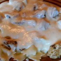 Chicken Alfredo · Marinated chicken breast served on choice of pasta. Topped with alfredo sauce. Served with d...